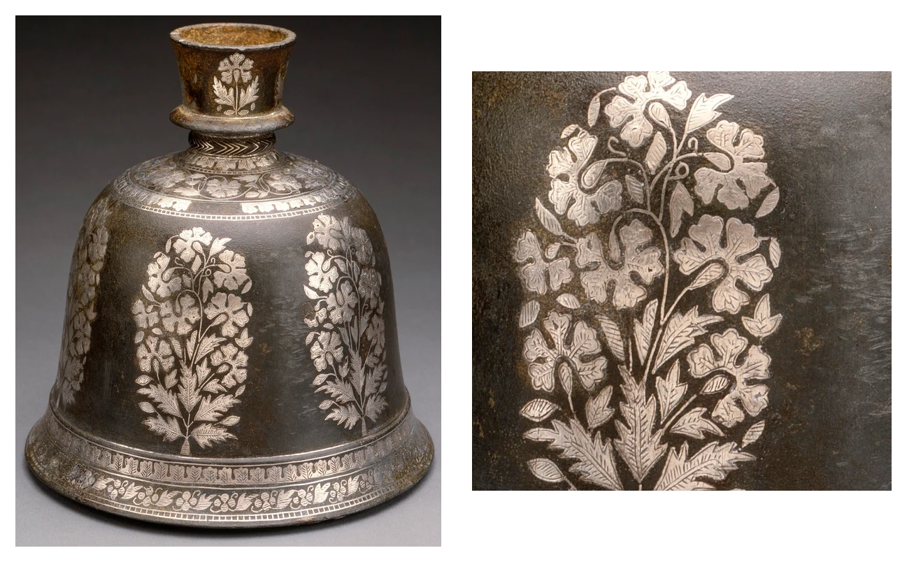 A bidri hookah base with dense silver floral inlay on a matt black ground, with a close detail showing the edge of a silver leaf set into the engraved zinc alloy.